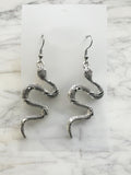 Coiled serpent Tibetan silver dangle earrings on surgical steel hooks, front view