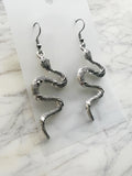 Coiled serpent Tibetan silver dangle earrings on surgical steel hooks, front view