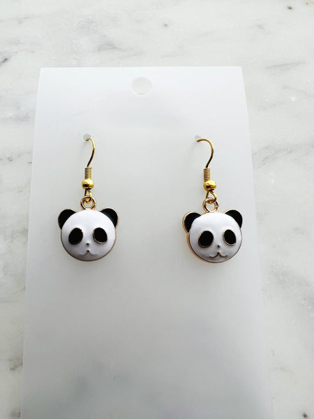 Enamel Panda earrings on a marble background
