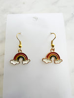 Kawaii Rainbow and cloud earrings on a white card with marble background