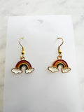 Kawaii Rainbow and cloud earrings on a white card with marble background