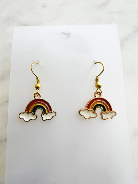 Kawaii Rainbow and cloud earrings on a white card with marble background