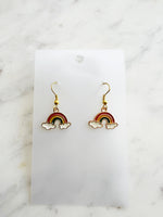 Kawaii Rainbow and cloud earrings on a white card with marble background