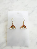 Kawaii Rainbow and cloud earrings on a white card with marble background