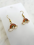 Kawaii Rainbow and cloud earrings on a white card with marble background