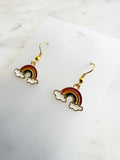 Kawaii Rainbow and cloud earrings on a white card with marble background