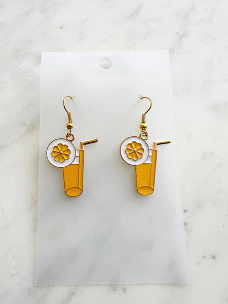 Pair of kawaii earrings with a cocktail design on a marble background