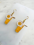 Pair of kawaii earrings with a cocktail design on a marble background