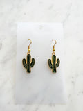 Kawaii Cactus-shaped earrings on a white card with a marble background