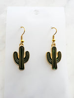 Kawaii Cactus-shaped earrings on a white card with a marble background