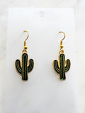 Kawaii Cactus-shaped earrings on a white card with a marble background