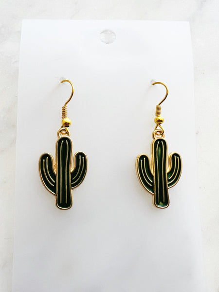 Kawaii Cactus-shaped earrings on a white card with a marble background