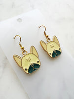 Kawaii Gold French bulldog earrings on a white card with a marble background