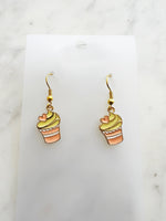 Kawaii Cupcake-shaped earrings on a clear card with a marble background