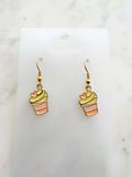 Kawaii Cupcake-shaped earrings on a clear card with a marble background
