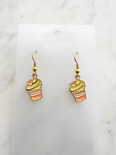 Kawaii Cupcake-shaped earrings on a clear card with a marble background