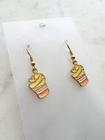 Kawaii Cupcake-shaped earrings on a clear card with a marble background