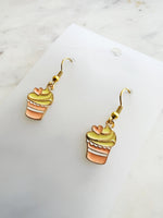 Kawaii Cupcake-shaped earrings on a clear card with a marble background