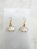 Kawaii Sheep-shaped earrings on a white card with a marble background
