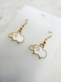 Kawaii Sheep-shaped earrings on a white card with a marble background