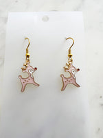Pink Christmas Reindeer-shaped earrings on a white card with a marble background