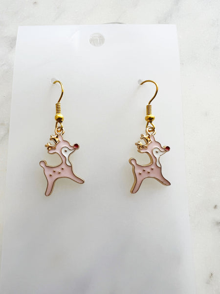 Pink Christmas Reindeer-shaped earrings on a white card with a marble background