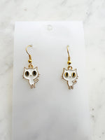 Kawaii Cat-shaped earrings on a white card with a marble background