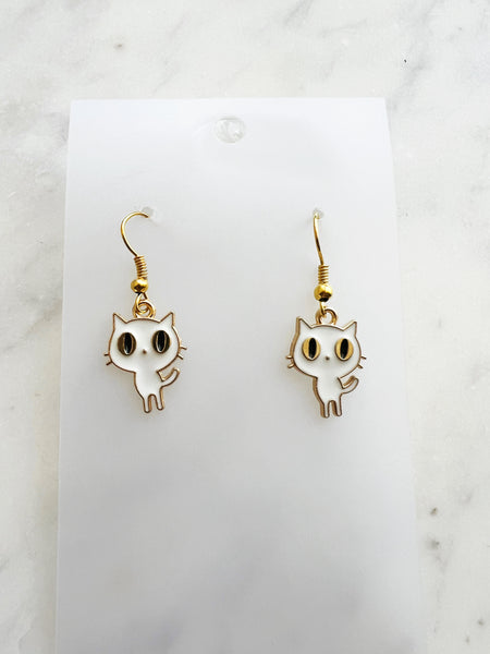 Kawaii Cat-shaped earrings on a white card with a marble background