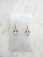 Kawaii Cat-shaped earrings on a white card with a marble background