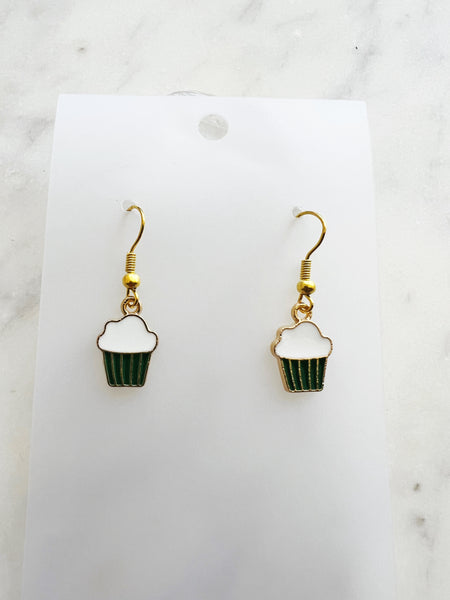 Kawaii Cupcake-shaped earrings on a white card with a marble background