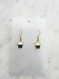 Kawaii Cupcake-shaped earrings on a white card with a marble background