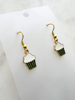 Kawaii Cupcake-shaped earrings on a white card with a marble background