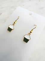 Kawaii Cupcake-shaped earrings on a white card with a marble background