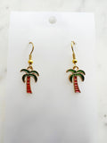 Kawaii Palm tree earrings on a white card with a marble background