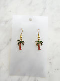 Kawaii Palm tree earrings on a white card with a marble background