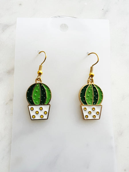 Kawaii Cactus-shaped earrings on a white card with a marble background