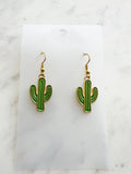 Kawaii Cactus-shaped earrings on a white card with a marble background