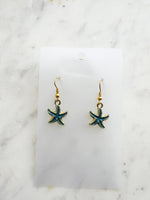 Kawai Starfish-shaped earrings on a marble surface