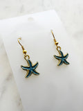 Kawai Starfish-shaped earrings on a marble surface