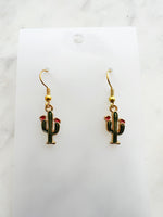 Kawaii Cactus-shaped earrings on a white card with a marble background