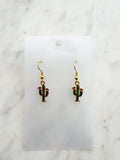 Kawaii Cactus-shaped earrings on a white card with a marble background