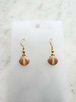 Kawai Shell-shaped earrings on a white card with a marble background