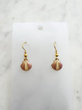Kawai Shell-shaped earrings on a white card with a marble background