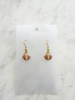 Kawai Shell-shaped earrings on a white card with a marble background