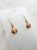 Kawai Shell-shaped earrings on a white card with a marble background