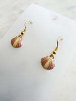 Kawai Shell-shaped earrings on a white card with a marble background