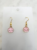 Pink cloud shaped earrings on a marble background