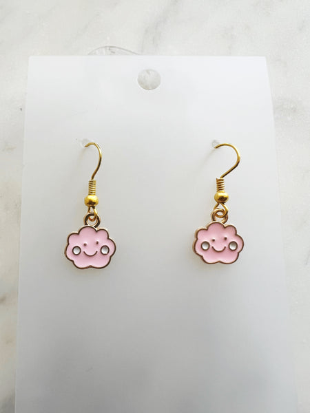Pink cloud shaped earrings on a marble background