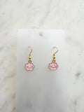 Pink cloud shaped earrings on a marble background