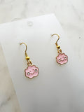 Pink cloud shaped earrings on a marble background